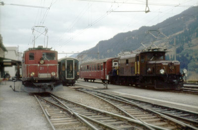 Furka-Oberalp-Bahn und Rhätische Bahn, Disentis, HGe 4/4 31, Ge 6/6 I 413, Aufnahme 1972